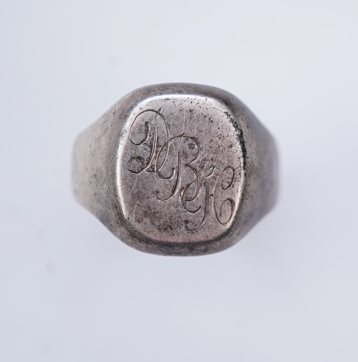 A collection of silver jewels, comprising: a bangle; a chain necklace suspending two winding toothpicks, one with toothpick deficient; a rope twist chain; a pair of cufflinks with the initials DBH; a pendant of abstract